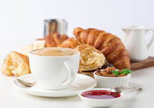 Fresh delicious breakfast with Coffee, crispy croissants, jam on white wooden background. Selective focus. Romantic french weekend concept. Copy space.